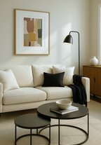 Modern living room with a white sofa, black coffee table, and abstract green and yellow art on the wall.