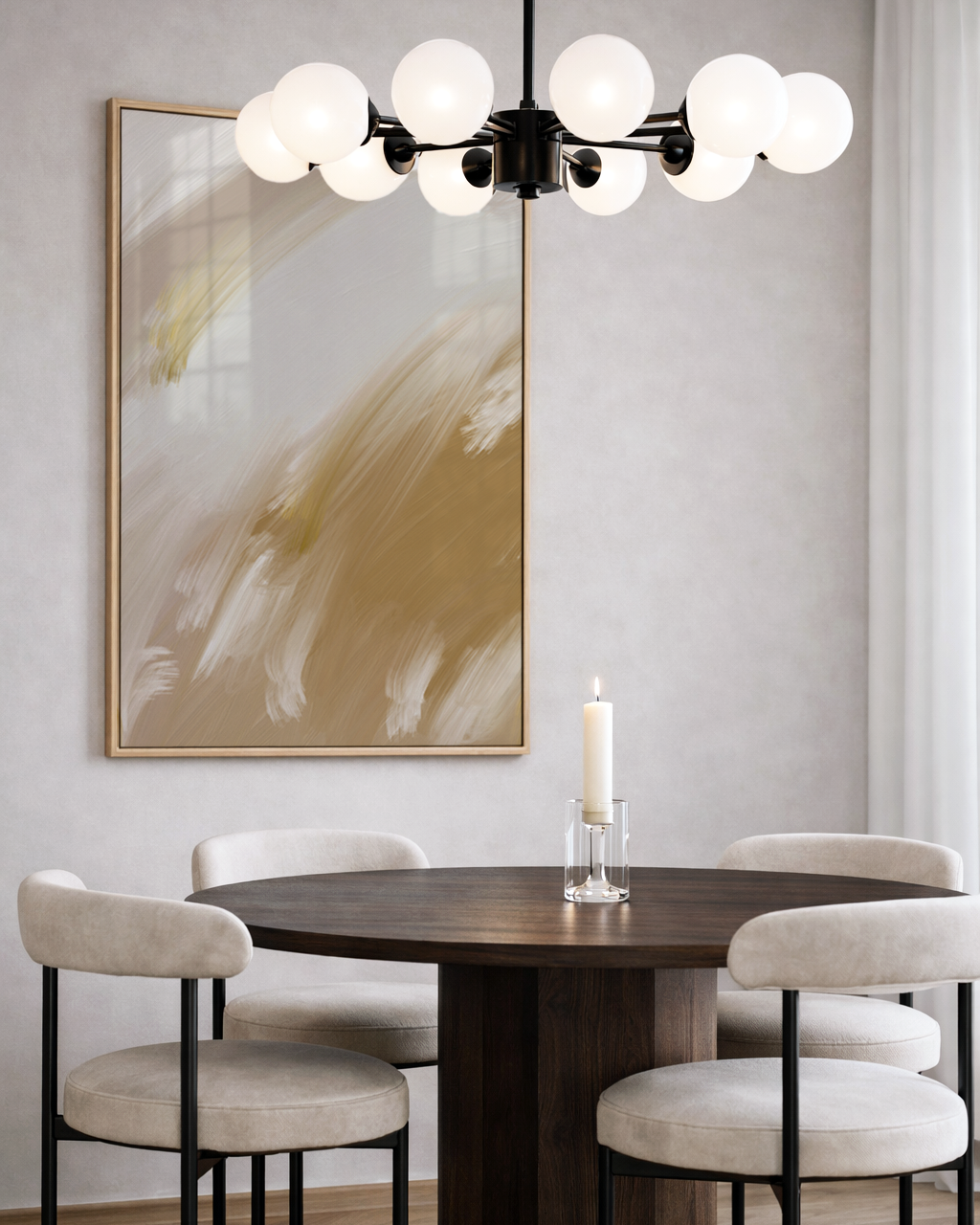 Dining room with round table, chairs, and abstract gold art on the wall.