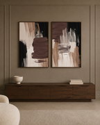 Two framed abstract wall art prints with brown, beige, black, and white brushstrokes, displayed side by side.