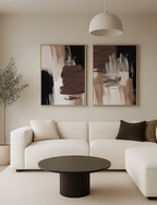 Asbtract brown and neutral wall art set in a modern beige living room with black coffee table.
