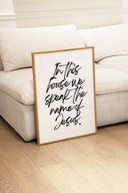 Interior styling scene with framed christian print in front of sofa