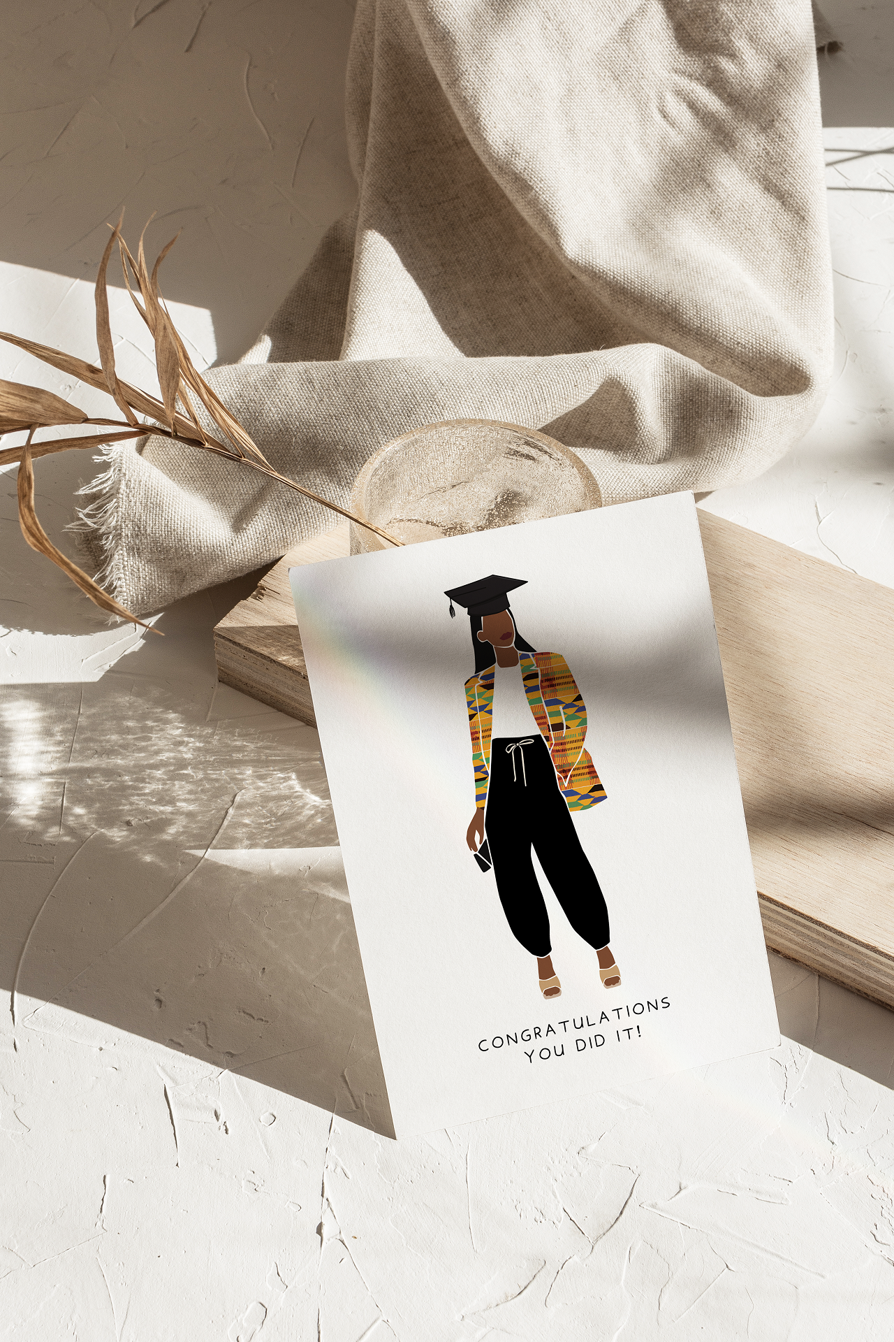 Graduation greeting card featuring a joyful illustrated Black woman in academic dress