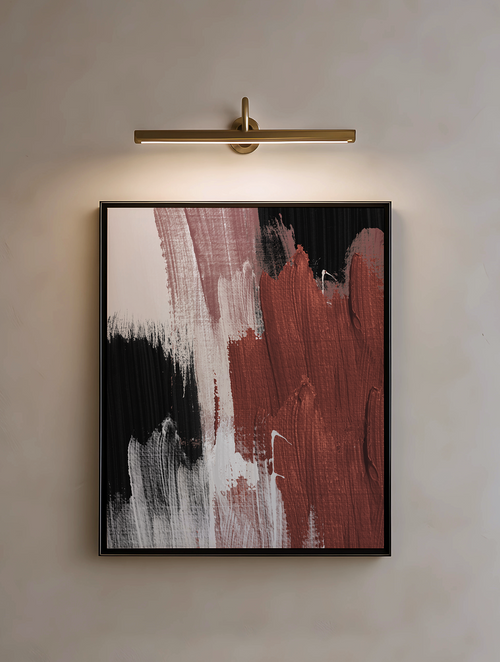 Abstract art piece with black, white, and red brushstrokes on a wall with a light fixture.