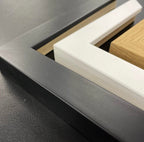 Example of Akua home frames in black, oak and white.