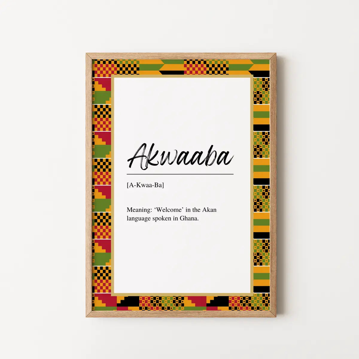 A framed wall art print featuring the word 'Akwaaba' with a colorful African Kente-style pattern border, shown hanging on a plain light wall.