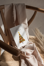 Christmas greeting card showcasing a kente-inspired tree in a modern style