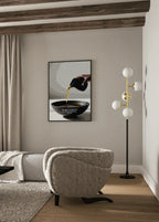 Framed artwork displayed in a minimal room with soft lighting