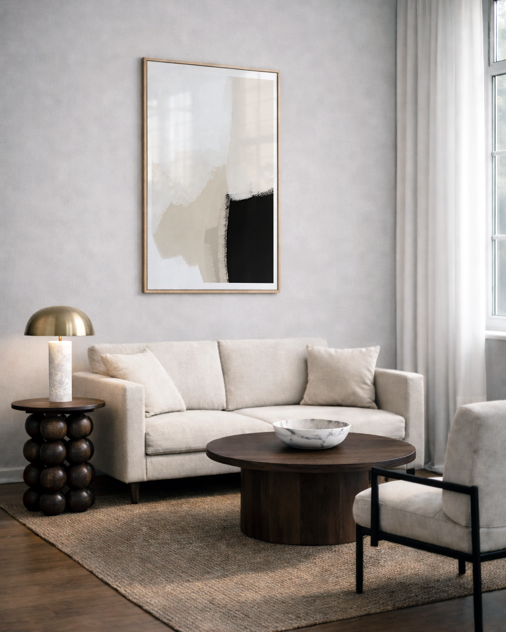 Modern living room with a beige sofa, wooden coffee table, and abstract neutral black art on the wall.