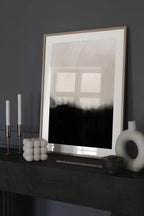 Beige and black neutral modern wall art styled on a console table