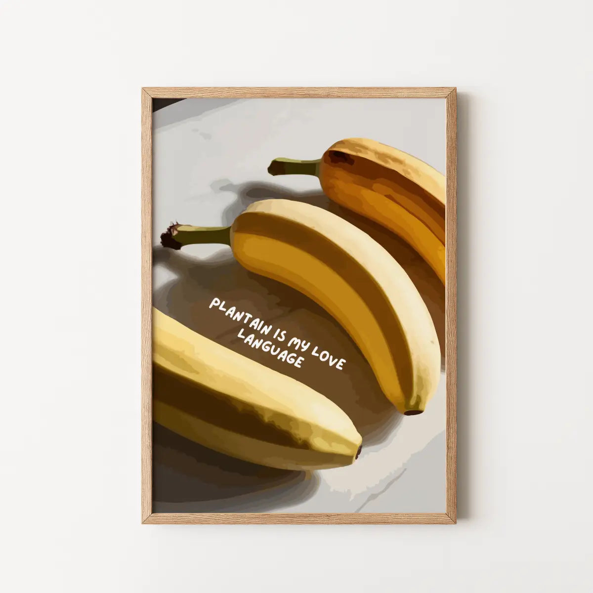 A framed art print featuring a stylized illustration of three bananas on a light gray background with the text 'PLANTAIN IS MY LOVE LANGUAGE'. 