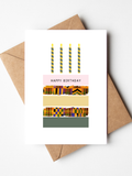 Birthday greeting card featuring an illustrated cake design on a clean background