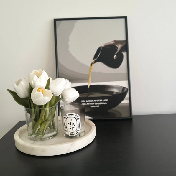 Candle, flowers, and Christian framed picture on a table
